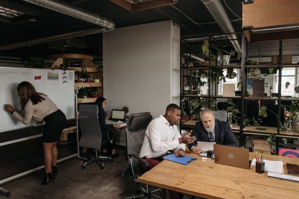 Equipe diversa reunida em um escritório moderno, colaborando em uma discussão de planejamento.